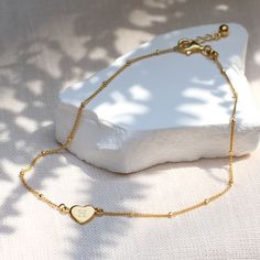 Our Personalised Gold Heart Charm Anklet is the perfect summer accessory. This dainty and delicate gold anklet features a satellite chain with a beautifully crafted heart charm at its centre. The heart can be engraved with the initial of your choice, adding a unique and personal touch.

Ideal for summer, this pretty gold anklet is a lovely treat for yourself or a thoughtful gift for a loved one. Personalised Baby Bracelet, Mens Bracelet Personalized, Milestone Birthday Gifts, Engraved Handwriting, Charm Anklet, Ankle Jewelry, Boys Jewelry, Gold Anklet, Month Gifts