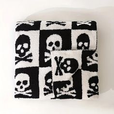 a black and white blanket with skulls on it