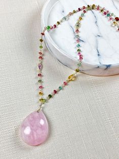 "Morganite pendant necklace is bold with a romantic flair! This large 30mm x 25mm gemstone has a smooth, high polish finish with a milky pink luster within it! The back of the gem is flat so it lies gently against you. You will love the multi gemstone chain with small gems of amethyst, topaz, citrine, peridot and garnet. A true one of a kind piece of jewelry that you will cherish for a lifetime. The necklace measures 19 inches with Sterling silver lobster claw clasp. The pendant hangs another 1. Handmade Pink Teardrop Necklaces, Handmade Pink Teardrop Necklace, Pink Teardrop Gemstone Accented Jewelry, Pink Pendant Crystal Necklace With Natural Stones, Pink Teardrop Gemstone Accent Jewelry, Rose Quartz Pendant Necklace With Gemstones, Pink Gemstone Briolette Necklace, Pink Teardrop Gemstone Jewelry, Pink Necklace With Natural Stones For Gifts