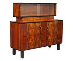 an art deco sideboard with glass doors on the top and bottom, in walnut