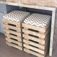 some wooden crates stacked on top of each other in front of a kitchen countertop