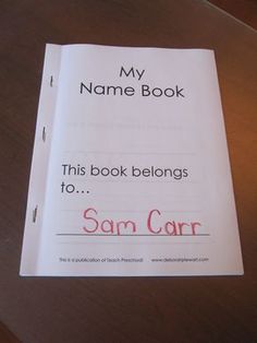 a book that is sitting on top of a table with the title'my name book, this book belongs to sam carr