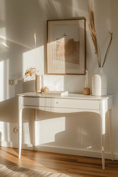 Sunlit space featuring a minimalist white desk adorned with natural decor and framed artwork, embodying modern farmhouse chic living room ideas.