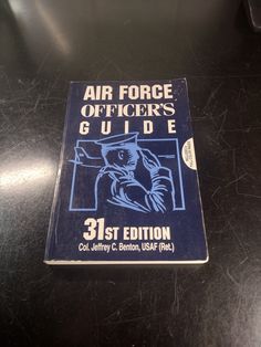 an air force officer's guide sits on a table