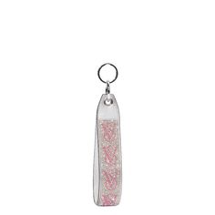 a keychain with pink and white designs on the front, hanging from a metal hook