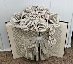 an open book with flowers made out of pages