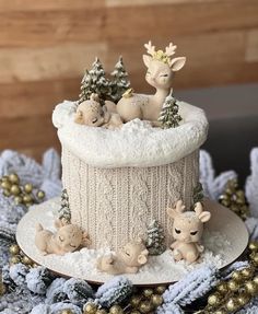 a christmas cake decorated with animals and trees