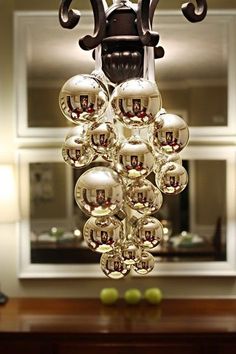 a chandelier made out of glass balls hanging from it's ceiling in a kitchen