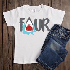 a white t - shirt with the word four printed on it next to denim shorts