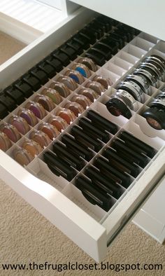 an organized drawer filled with lots of different types of pens and pencils on top of each other