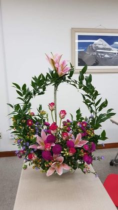 an arrangement of flowers in a vase on a table