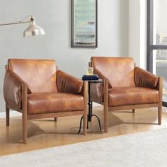 two brown leather chairs sitting next to each other