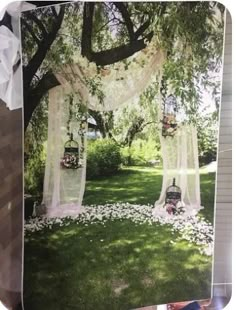 an outdoor wedding setup with flowers and birdcages