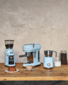 there are many different types of coffee machines on the table together, including one with an espresso machine