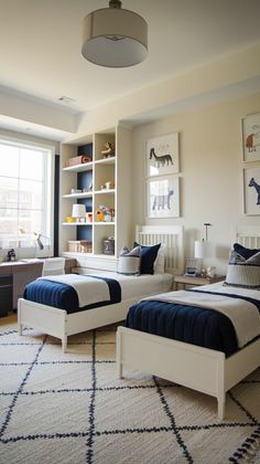 two beds in a bedroom with blue and white bedding on the covers, pillows and rugs