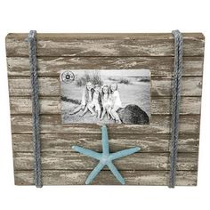 an old wooden frame with two girls and a starfish