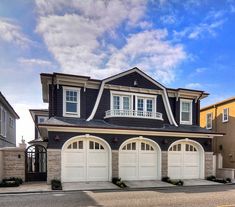 a two story house with three car garages