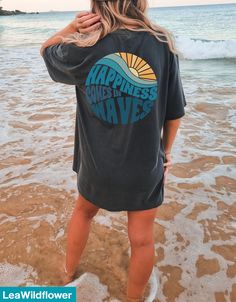 Happiness Comes in Waves tee, Summer Graphic Tees, Beach T-shirt, Retro Summer Shirt, Oversized shirt, Positive Shirt, Comfort Colors summer Shirt Printed on Comfort Colors® tshirts for that amazing vintage look and feel. ★Shipping Shipping Time Varies by location Our turn around time is 1 to 3 business days. ★Sizing and Coloring please look at our size and color chart in the images These Shirts are unisex sizing. For a relaxed look: order your normal size for an oversized look: size up 1-3 size Oversized Vsco Crew Neck T-shirt, Black Crew Neck Camp Shirt For Summer, Casual Crew Neck Camp Shirt With Graphic Print, Black Screen Print Tops For Beach, Black Screen Print Top For Beach, Vsco Crew Neck Top With Text Print, Vsco Style Crew Neck Top With Text Print, Vsco Style Text Print Crew Neck Top, Casual Short Sleeve Screen Print Camp Shirt