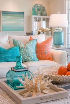 a living room filled with lots of furniture and pillows on top of a white table