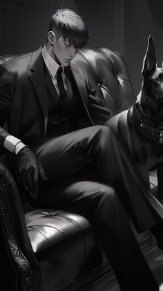 a man in a suit and tie sitting on a chair with his dog