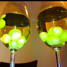 two wine glasses with grapes in them and the caption reads, freeze grapes to chill white wine without watering it down