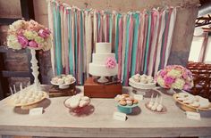 a table topped with lots of cakes and desserts