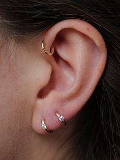 The perfect mini huggies, the Elfins work well on most all piercings. A snug fit on the lobe, and for cartilage earscaping, these 14Kt gold high polished huggies are everyday essentials. 14KT Yellow Gold 8.6mm Diameter 1.4mm Thick Sold as Pair Made in Italy Materials Globally Sourced 4 Lobe Piercings, All Piercings, Gold Huggie Earrings, Maximalist Style, Girl Vibe, Helix Hoop, Earrings Aesthetic, Lobe Piercing, Summer Girl