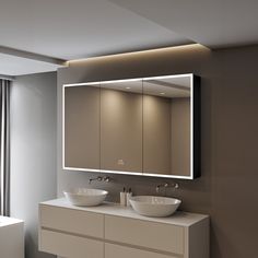 a bathroom with two sinks and a large mirror