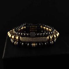 Chase your luck with the Vegas bracelet stack! The Vegas stack features trifecta of beaded beauties - black onyx, golden glitz, and rhodium PVD for a triple threat of style. Plus, a lucky dice and CZ bar for a dash of extra luck. Indulging the adventurous spirit and wandering heart that lives within all of us, our men's bracelet stacks have been crafted to provide a touch of class to your wardrobe throughout the year. Each exquistely curated stack includes a mix of spiritually healing gemstones Triple Threat, Meaningful Jewelry, Gemstone Beaded Bracelets, Premium Gift, Bar Bracelets, Black Rhodium, Gemstone Healing, Jewelry Pouch, Bracelet Stack