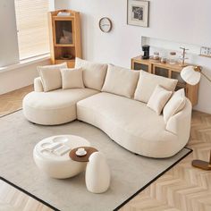 a living room with a large sectional couch and coffee table on the floor in front of it