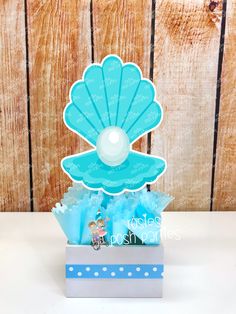 a blue box with some candy in it on a white table next to a wooden wall