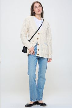 A true classic, this relaxed fit cardigan comes in a thick cable knit. Contrast pockets, a button front and boyfriend body make it the perfect addition to your fall wardrobe. Layer over a timeless white tee or wear open over just about anything. Product Details Material: 70% Polyester, 30% Acrylic. Fit: Relaxed boyfriend fit. Body length: 24" from shoulder to hem (size Small). Fabric: Thick cable knit. Features: Button front, v-neckline, boyfriend body, weaved cable knit design, contrast trimmed Oversized Cotton Cable Knit Cardigan, Oversized Cable Knit Cotton Cardigan, White Cable Knit Button-up Outerwear, Relaxed Fit Cable Knit Cardigan For Layering, Casual Cable Knit Cardigan For Everyday, Casual Everyday Cable Knit Cardigan, Classic White Sweater With Pockets, White Cable Knit Outerwear For Work, Classic White Cardigan With Pockets