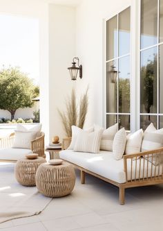 a living room filled with lots of furniture next to a large glass doored window