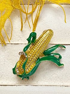 Adorable smaller-sized brooch pin is yellow enamel corn with green enamel leaves and clear rhinestone accents! Not intended for children ages 13 and under. Also, for many items we can accommodate large orders, so please send us a message. Yellow Enamel Brooches For Gifts, Corn Vegetable, Urban Farmer, Yellow Corn, County Fair, Pretty Packaging, Green Enamel, Clear Rhinestones, Enamel Pin