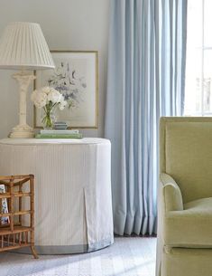 a living room with a couch, chair and lamp