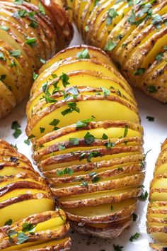 baked potatoes with cheese and herbs in them on a white plate text reads how to make perfect hasselback potatoes