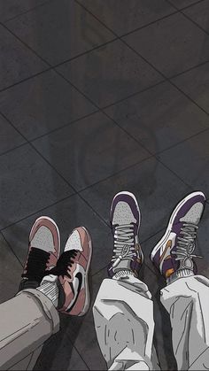 two people standing on the ground with their feet up in front of them, wearing sneakers