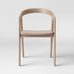 a chair made out of wood with a curved back and seat, viewed from the side