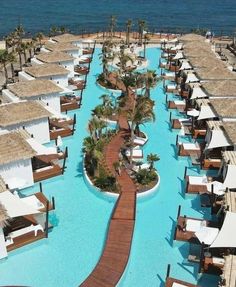 an aerial view of a resort pool and beach