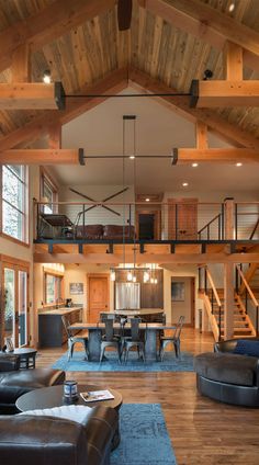 a living room filled with furniture next to a wooden floor covered in lots of windows