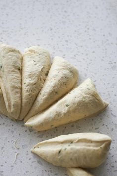 four pieces of bread are arranged on a white surface