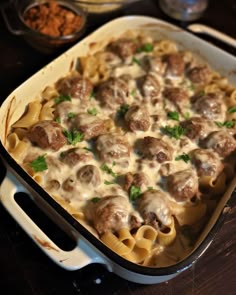 a casserole dish filled with meatballs and cheese