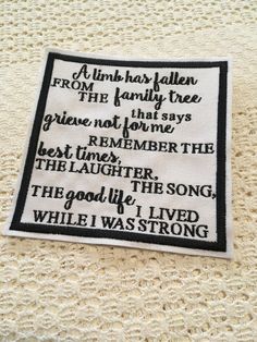 a white and black embroidered patch with words on the bottom that says, a little has fallen from the family tree