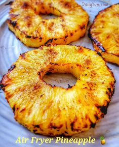 grilled pineapples on a white plate with the words air fryer pineapple