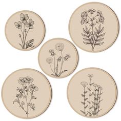 four coasters with flowers drawn on them