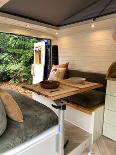 the inside of a camper with a table and couch