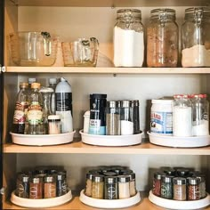 the shelves are filled with many different types of spices and condiments in glass jars