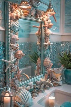 a bathroom sink sitting under a mirror covered in seashells