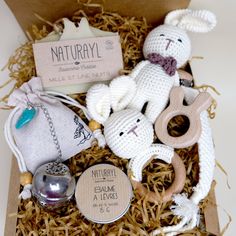 a box filled with stuffed animals and other items on top of wooden floor next to a tag