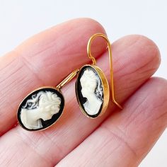 "This lovely pair of 1\" long earrings are made with 14X10 mm black resin vintage cameos set in 24K antiqued gold plated settings with attached long elegant wires. The earrings are very lightweight. Find a matching necklace here: https://www.etsy.com/listing/643886232 Shipped in a gift box." Cameo Earrings Studs, Classic Cameo Earrings, Classic Cameo Earrings Gift, Cameo Drop Earrings As Gift, Cameo Drop Earrings Jewelry Gift, Elegant Cameo Earrings As Gift, Gift Cameo Drop Earrings Jewelry, Elegant Cameo Earrings For Gift, Elegant Cameo Drop Earrings